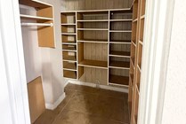 Spacious walk-in closet with modern shelving and ample storage solutions.