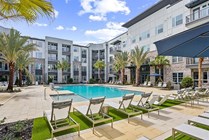 Experience the ultimate in relaxation at this luxury apartment's poolside oasis.