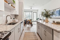 Explore this inviting urban kitchen that seamlessly transitions into a bright living area.