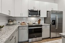 Experience the elegance of a contemporary kitchen with high-end finishes and ample storage.